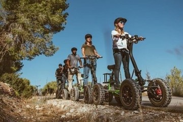 a group of people riding on a EZ raider ATV